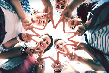 Image showing group of teenagers showing finger five