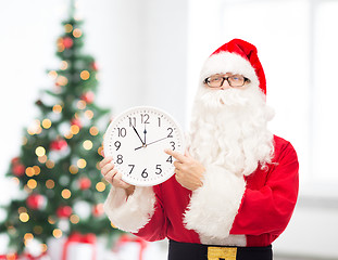 Image showing man in costume of santa claus with clock