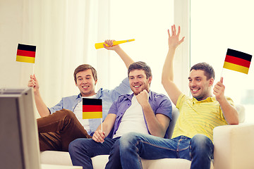 Image showing happy male friends with flags and vuvuzela