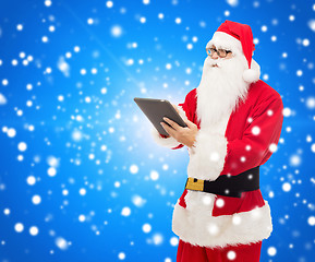 Image showing man in costume of santa claus with tablet pc