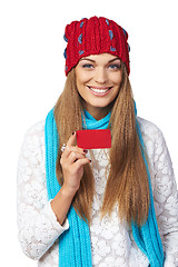 Image showing Female in winter hat and scarf showing blank credit card