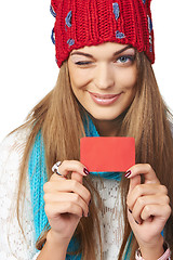 Image showing Female in winter hat and scarf showing blank credit card