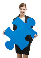 Image showing Businesswoman with a puzzle piece