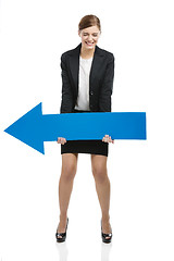 Image showing Business woman holding a blue arrow