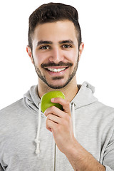 Image showing Man tasting a green fresh apple