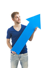 Image showing Young man holding a blue arrow