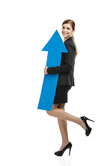 Image showing Business woman holding a blue arrow