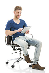 Image showing Young man working with a tablet