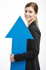 Image showing Business woman holding a blue arrow