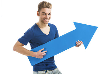 Image showing Young man holding a blue arrow