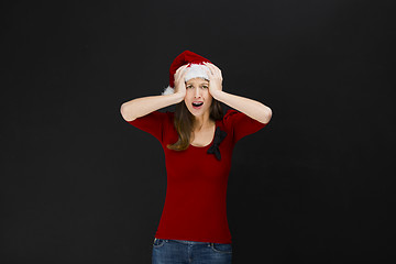 Image showing Beautiful woman wearing a santa hat