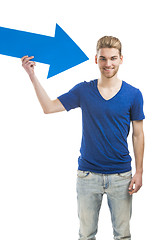 Image showing Young man holding a blue arrow