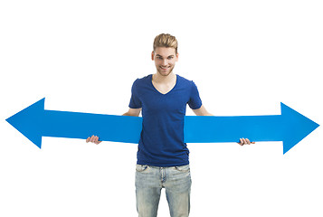 Image showing Young man holding a blue arrow