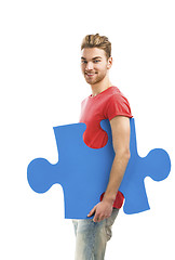 Image showing Young man holding a puzzle piece