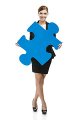 Image showing Businesswoman with a puzzle piece