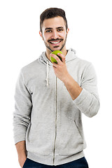 Image showing Man tasting a green fresh apple