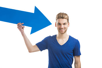 Image showing Young man holding a blue arrow