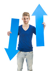 Image showing Young man holding a blue arrow