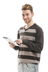 Image showing Young man working with a tablet