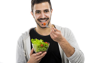 Image showing Young man eating a salad