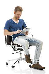 Image showing Young man working with a tablet