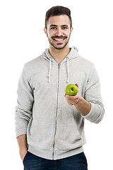 Image showing Man tasting a green fresh apple