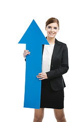 Image showing Business woman holding a blue arrow