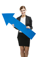 Image showing Business woman holding a blue arrow