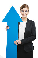 Image showing Business woman holding a blue arrow