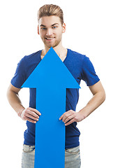 Image showing Young man holding a blue arrow