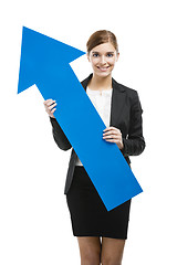 Image showing Business woman holding a blue arrow