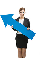 Image showing Business woman holding a blue arrow