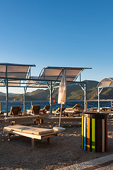 Image showing Sun loungers with umbrellas on the beach