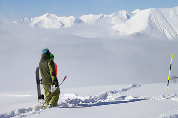 Image showing Snowboarders on off-piste slope with new fallen snow