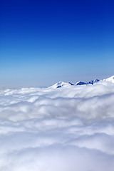 Image showing Mountains under clouds and clear blue sky