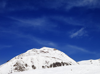 Image showing Winter mountains and ski slope at sun day