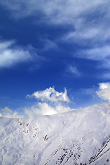 Image showing Off-piste slope and blue sky with clouds