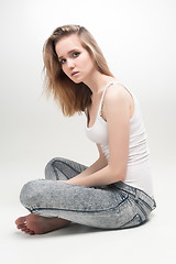 Image showing Attractive sad woman on floor