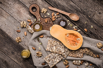 Image showing Pumpkin nuts and cookies with seeds on wooden table