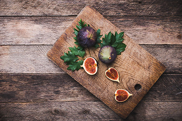 Image showing Figs on chopping board and wooden table