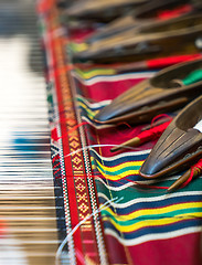 Image showing Weaving shuttles and colorful textile 