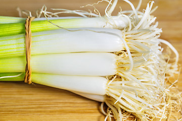 Image showing spring onion on a plank