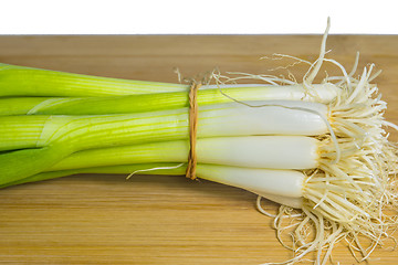 Image showing spring onion on a plank