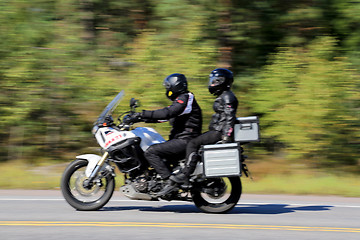 Image showing Two Bikers Riding a Motorcycle, motion blur