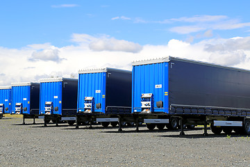 Image showing Row of Blue Trailers on a Yard