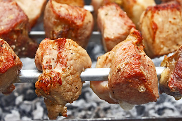 Image showing Shish kebab on metal skewers close-up