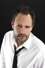 Image showing Attractive man with white shirt and black tie looks into the cam