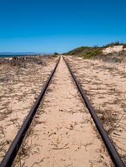 Image showing Steel Railroad Tracks on Sand Beach