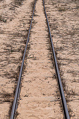 Image showing Steel Railroad Tracks on Sand Beach