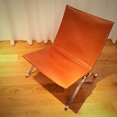 Image showing Leather chair on wooden floor